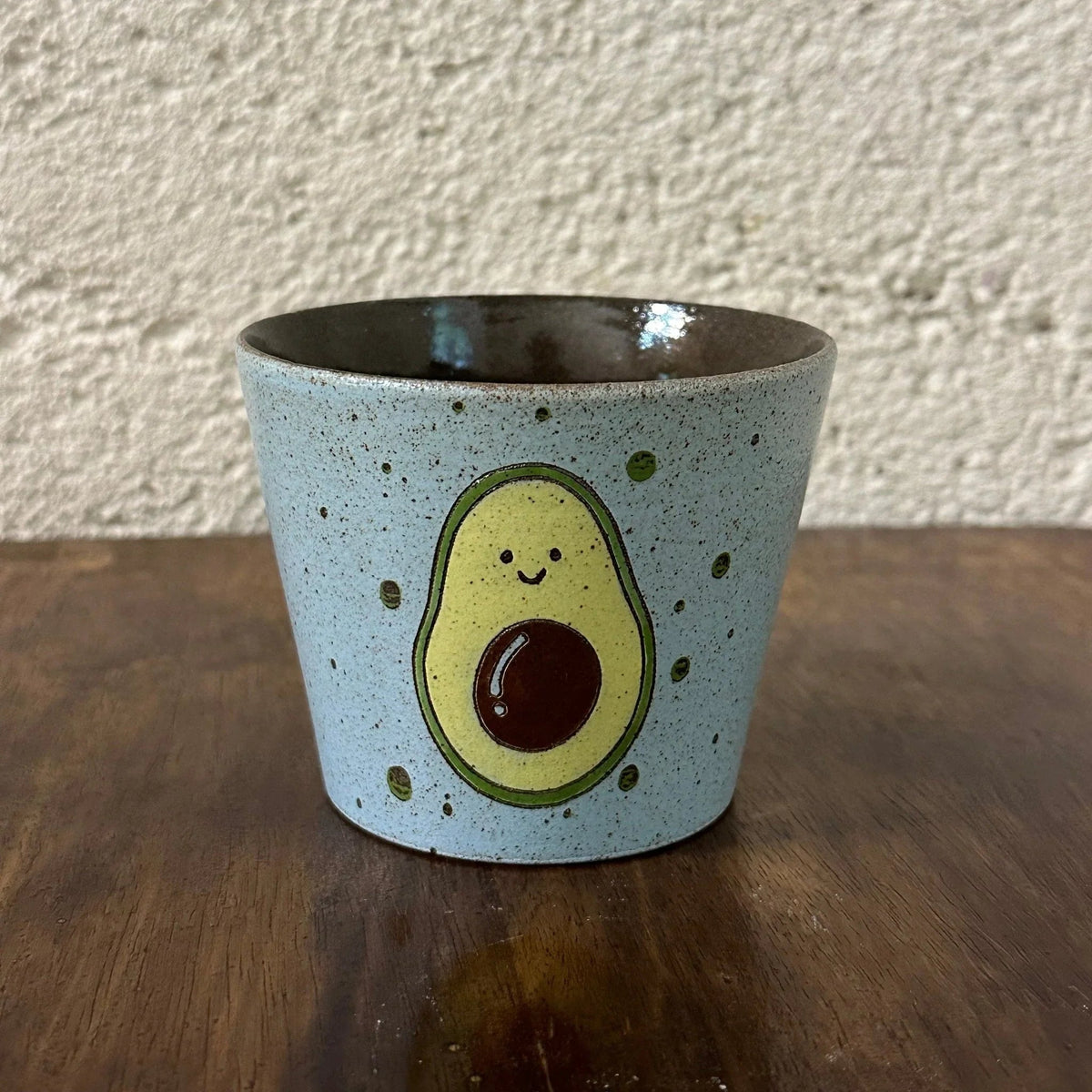 Handmade ceramic mug with cute avocado design, speckled light blue glaze, perfect for coffee or tea