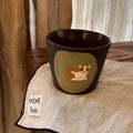 Handmade ceramic mug with cute cat illustration, perfect for coffee or tea, artisanal tableware