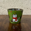 Handmade ceramic mug with cute white cat in red scarf, green speckled glaze, and coffee cup design