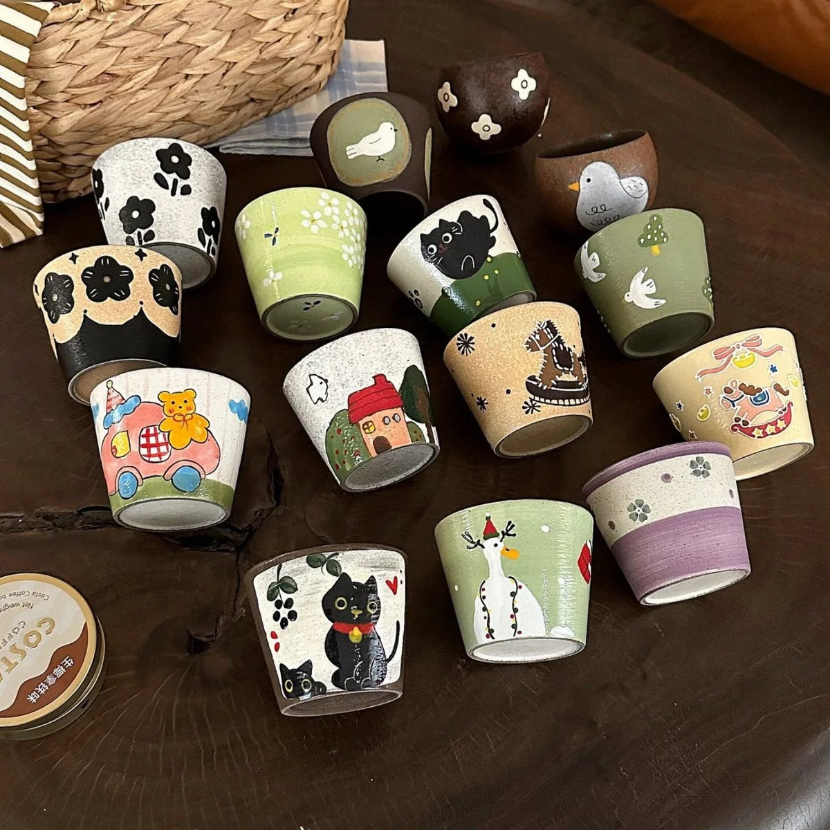 Hand-painted ceramic mugs with cute animal and floral designs, perfect for coffee or tea.