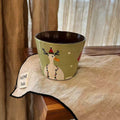Handmade ceramic mug with festive reindeer design, perfect for holiday coffee or tea