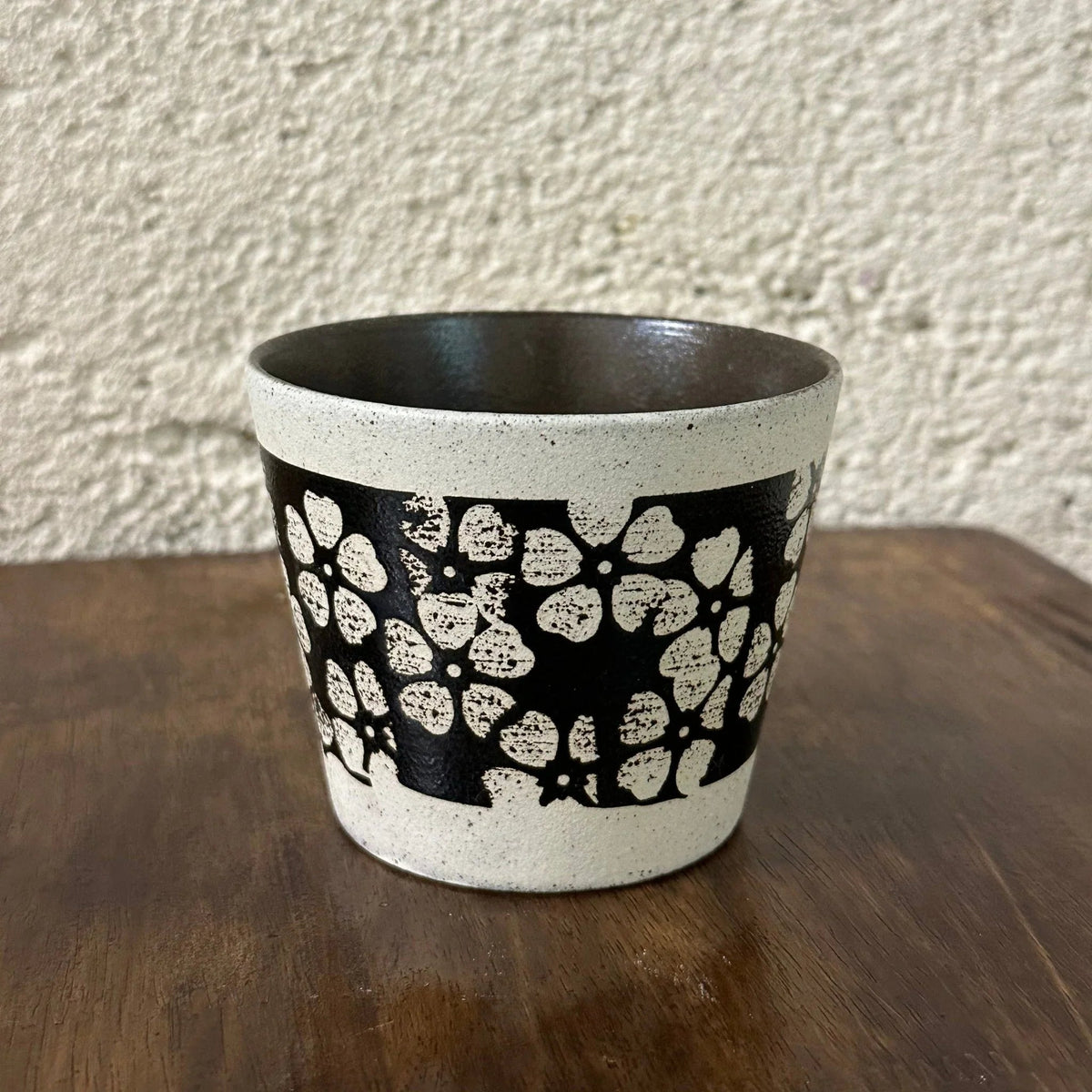 Handmade ceramic mug with black and white floral pattern, food-safe pottery for coffee or tea