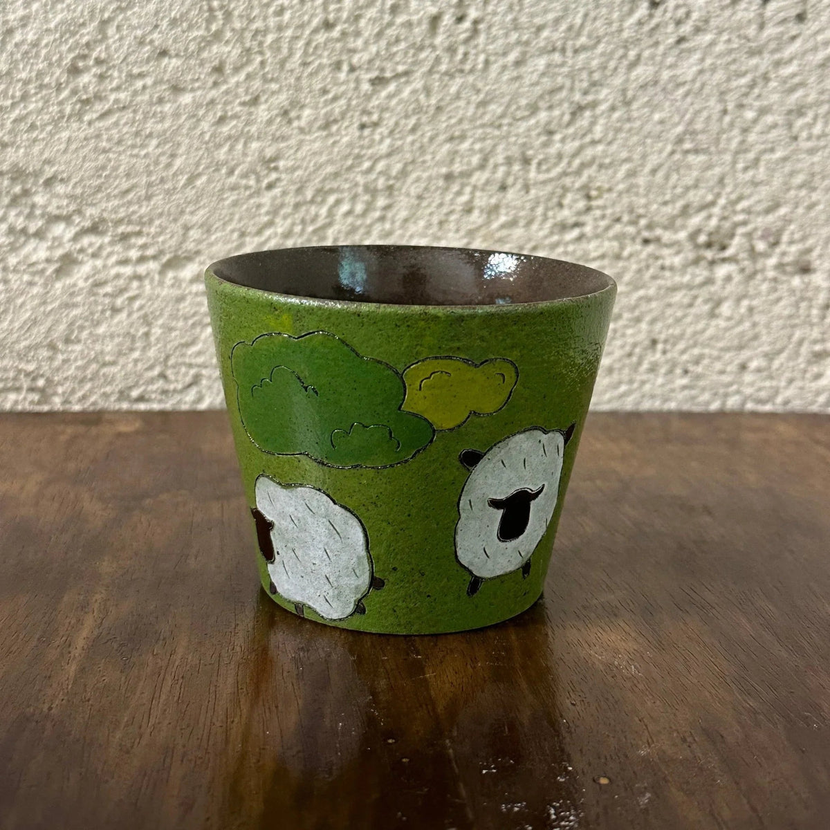 Handmade ceramic mug with sheep and clouds design, green glaze, food-safe tableware