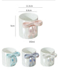 White ceramic mug with 3D bow handle, 350ml capacity, available in pink, blue, and silver