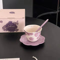 Purple floral ceramic mug with matching saucer and spoon, 'Morning Light' text, gift box labeled 'Embrace'