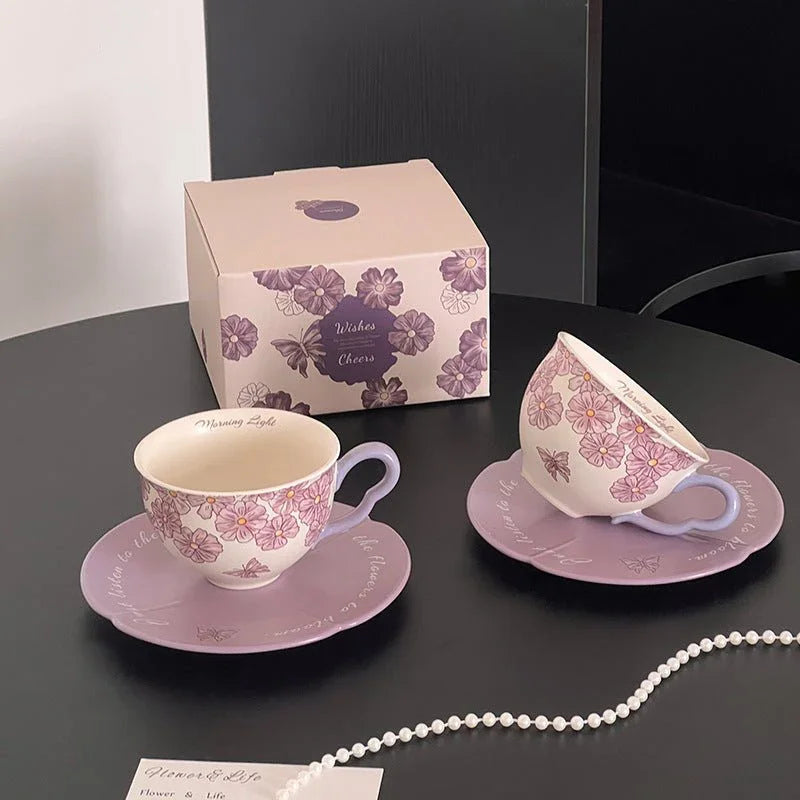Hand-painted floral ceramic tea cup and saucer set with delicate purple flowers, perfect for morning tea or coffee moments.