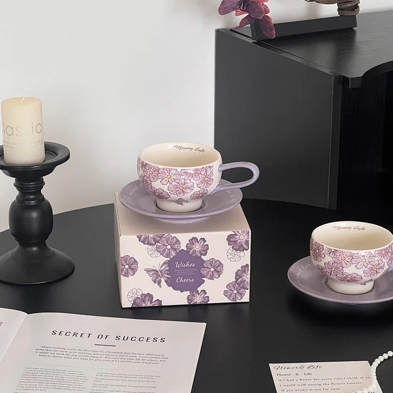 Purple floral ceramic tea cup and saucer set, handmade tableware with 'Morning Light' inscription, styled on black surface