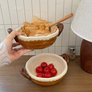 Handmade ceramic bowls with scalloped edges holding bread and cherry tomatoes, perfect for serving snacks or breakfast.